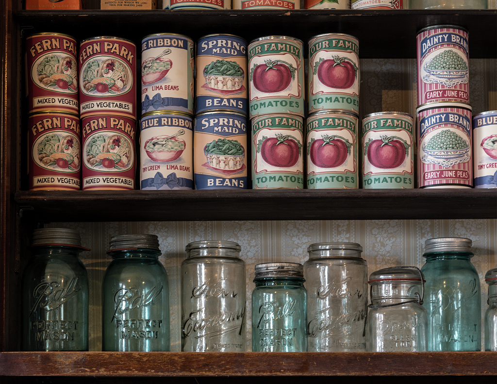 cans of food and mason jars in a pantry